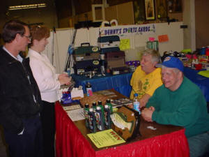 Ken and Dale Leinaar, left, meet with sports card dealer Denny Price and helper from Do-All, Inc.