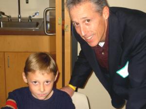 Author Reese Haller, 9, checks book sales with his father, Thomas Haller, co-publisher of Personal Power Press of Merrill.