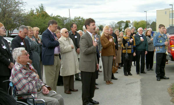 District Judge Tim Kelly, (Front,Center), sings at Bay County Medical Care Facility open house last Wednesday that drew several hundred dignitaries and visitors.