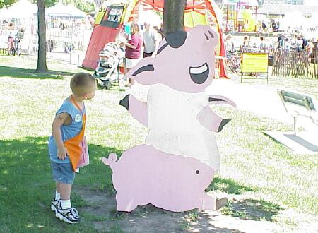 4 year old Hayden Lewicki checks the pig