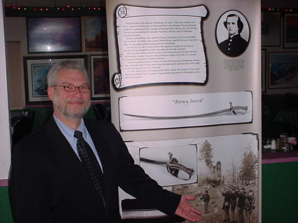 Eric Jylha, president of the Bay County Historical Society, with Birney Sword Display