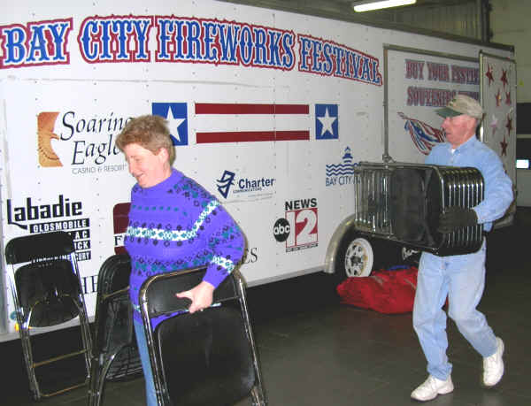 Chris Thurman and Bob Hartley help with setup for the 2006 Bay City Fireworks Telethon