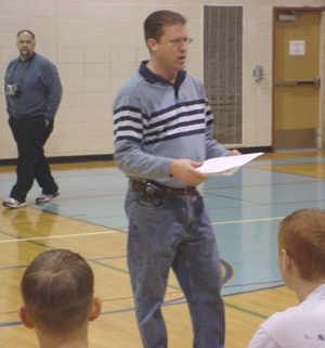 Elks Hoop Shoot Chairperson John Sauve directs competition at Garber High's gym.