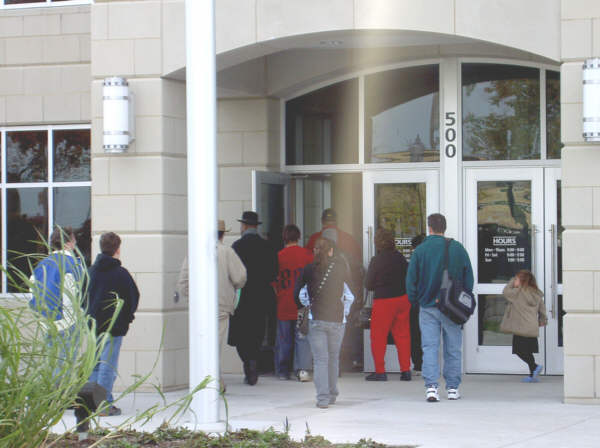 Lineup of people waiting to get into main branch library is almost an everyday occurrence, indicating high demand for library services.