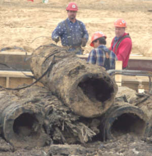 Eight-foot long sections of hollowed out wooden waterlines made by the Michigan Pipe Works are shown after being dug up at the new library site at Center and Jefferson. (All Photos by Andy Rogers)