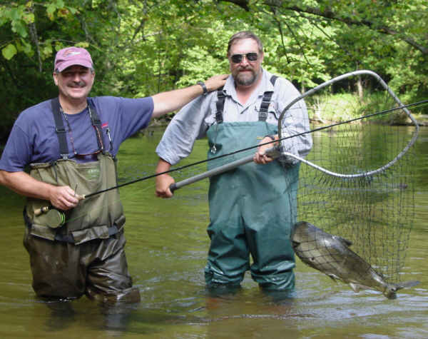 Nice Going Dan - Mark DeSanto (Left) congratulates Dan Schmidt on a fine netting job. <br> A 15LB+ King Salmon struggles in the net.