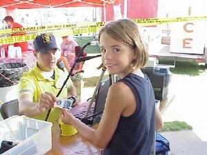 Officer Eric Berg makes an ID card for Stephanie Topping