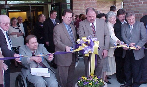 County Executive Tom Hickner and Lt. Gov. John Cherry, center, along with Library Director Linda Heemstra, right, lead the lineup of ribbon-cutters at the opening of the new Auburn Branch Library.