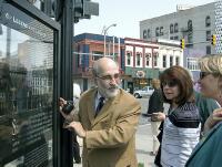 Andy Rogers points out fine details in etched glass photo