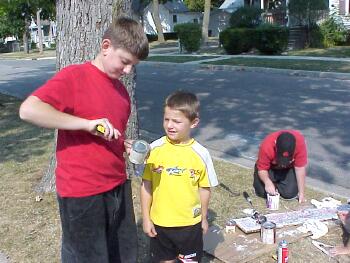 Joe Adams opens can of paint for Cole Brooks